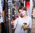 Woman choosing sunglasses in store