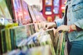Young Woman Choosing Vintage Vinyl LP In Records Shop Royalty Free Stock Photo