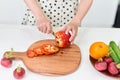 Young woman is chopping vegetables in the kitchen Royalty Free Stock Photo