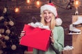 Young woman with christmas present boxes in front of christmas tree. Winter eve night emotion reactions. Funny happy Royalty Free Stock Photo