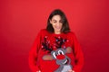 Young woman in a Christmas sweater on a red background Royalty Free Stock Photo