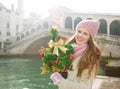 Young woman with Christmas tree near Rialto Bridge in Venice Royalty Free Stock Photo