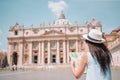 Happy young woman with city map in Vatican city and St. Peter`s Basilica church, Rome, Italy. Royalty Free Stock Photo