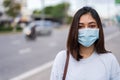 Woman in city street wearing face mask protective for spreading of coronaviruscovid-19 pandemic, new normal concept