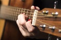 Young woman clamped with fingers guitar strings Royalty Free Stock Photo
