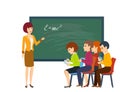 Young woman in classroom, teaches students and tells information material. Royalty Free Stock Photo