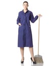 A young woman-cleaner stands with a broom in a blue robe. Royalty Free Stock Photo
