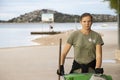 Young woman cleaner, working for city service, on her morning duty routine cleaning the beach in Vodice, Croatia