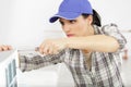 young woman cleaning air conditioning system at home Royalty Free Stock Photo