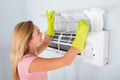 Woman Checking Air Conditioner Royalty Free Stock Photo