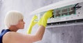 Young Woman Cleaning Air Conditioning System Royalty Free Stock Photo