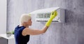 Young Woman Cleaning Air Conditioning System Royalty Free Stock Photo