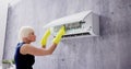 Young Woman Cleaning Air Conditioning System Royalty Free Stock Photo