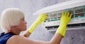 Young Woman Cleaning Air Conditioning System Royalty Free Stock Photo