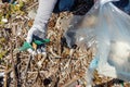 Young woman cleaning beach area from plastic Royalty Free Stock Photo