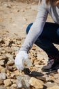 Young woman cleaning beach area from plastic bottles Royalty Free Stock Photo