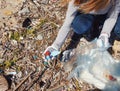 Young woman cleaning beach area and showing plastic bottle lids in hand Royalty Free Stock Photo