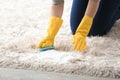 Young woman cleaning carpet at home Royalty Free Stock Photo