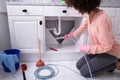 Woman Cleaning Clogged Sink Pipe Royalty Free Stock Photo