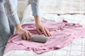 Young woman cleaning clothes with lint roller at home, closeup Royalty Free Stock Photo