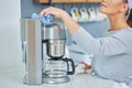 Young woman cleaning coffee pot or machine Royalty Free Stock Photo