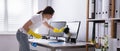 Woman Cleaning Computer Monitor In Office Royalty Free Stock Photo