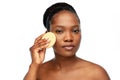 Young woman cleaning face with exfoliating sponge Royalty Free Stock Photo