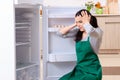 The young woman cleaning fridge in hygiene concept Royalty Free Stock Photo