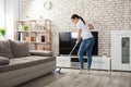 Young Woman Cleaning The Hardwood Floor Royalty Free Stock Photo