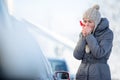 Young woman cleaning her car from snow and frost Royalty Free Stock Photo