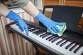 Woman cleans home  wipes dust from the piano and dreams about music  authentic inner life Royalty Free Stock Photo