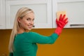 Young woman cleaning kitchen