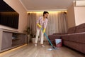 young woman cleaning and mopping floor at living room Royalty Free Stock Photo