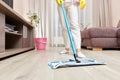 young woman mopping floor at living room Royalty Free Stock Photo