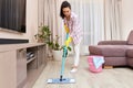 young woman cleaning and mopping floor at living room Royalty Free Stock Photo