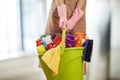 Young woman cleaning supplies in home