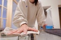 Young woman cleaning a table at home. Doing chores. Housekeeping. Spring clening Royalty Free Stock Photo