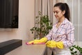 young woman cleaning table with microfiber cloth. Royalty Free Stock Photo