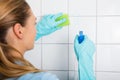 Young Woman Cleaning The Tiled Wall Royalty Free Stock Photo