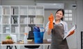 Young woman cleaning to disinfect computer and equipment on office table Cleaning staff or maid cleaning the office Royalty Free Stock Photo