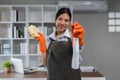 Young woman cleaning to disinfect computer and equipment on office table Cleaning staff or maid cleaning the office Royalty Free Stock Photo