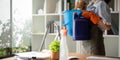 Young woman cleaning to disinfect the office office cleaning staff cleaning maid. Female cleaner holding a bucket with Royalty Free Stock Photo