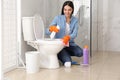 Young woman cleaning toilet bowl Royalty Free Stock Photo