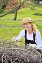 Young woman cleaning tree limbs