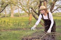 Young woman cleaning tree limbs