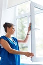 Young Woman cleaning window glass. Cleaning Company Worker Royalty Free Stock Photo