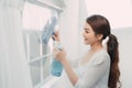 Young Woman Cleaning Windows Glass at the home Royalty Free Stock Photo