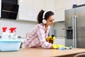 young woman cleaning wooden table with microfiber cloth. Royalty Free Stock Photo