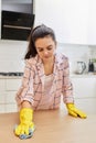 young woman cleaning wooden table with microfiber cloth. Royalty Free Stock Photo