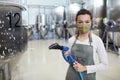 Young Woman Cleaning Workshop at Factory Royalty Free Stock Photo